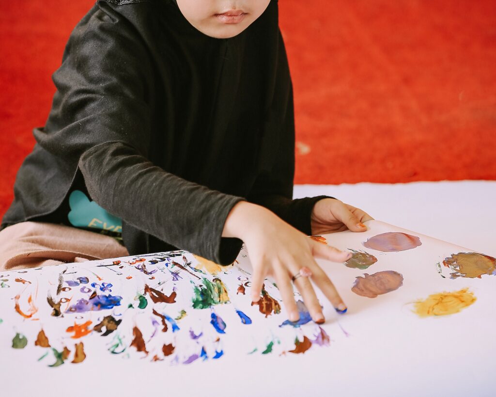 Child Playing with colour - child making art work